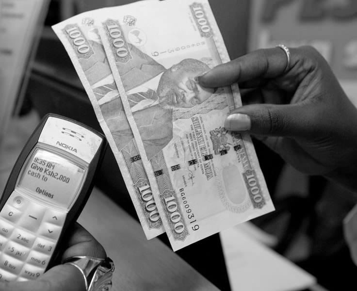 A money transfer being completed on a basic Nokia handset in Nairobi, 2012 — banking delivered without a bank branch.